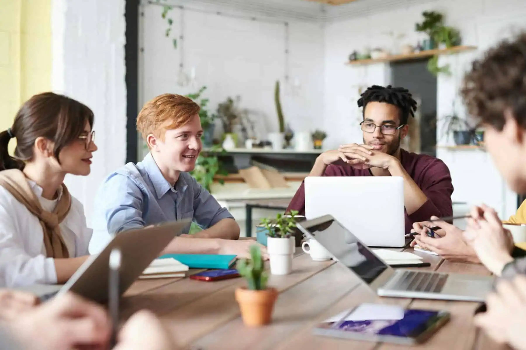Website header of Young professional team discussing business plan in the office