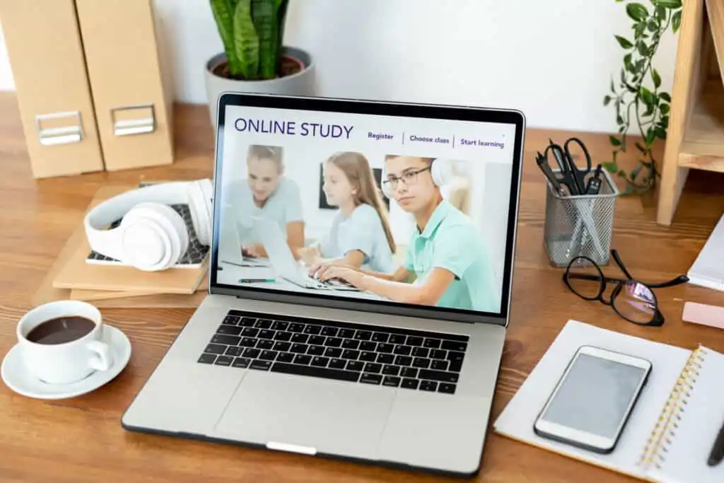Homepage of educational website on laptop display on workplace