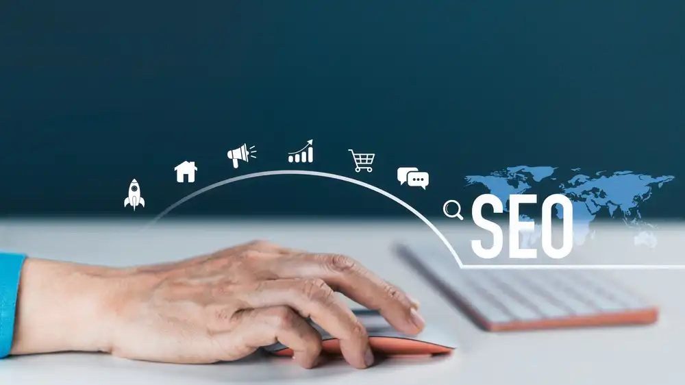 Why Most Charleston SEO Efforts Stall (and What Actually Moves the Needle) 2 Person's hand on a mouse with SEO icons and a world map, illustrating search engine optimization concepts on a blue background, with 'SEO' text.